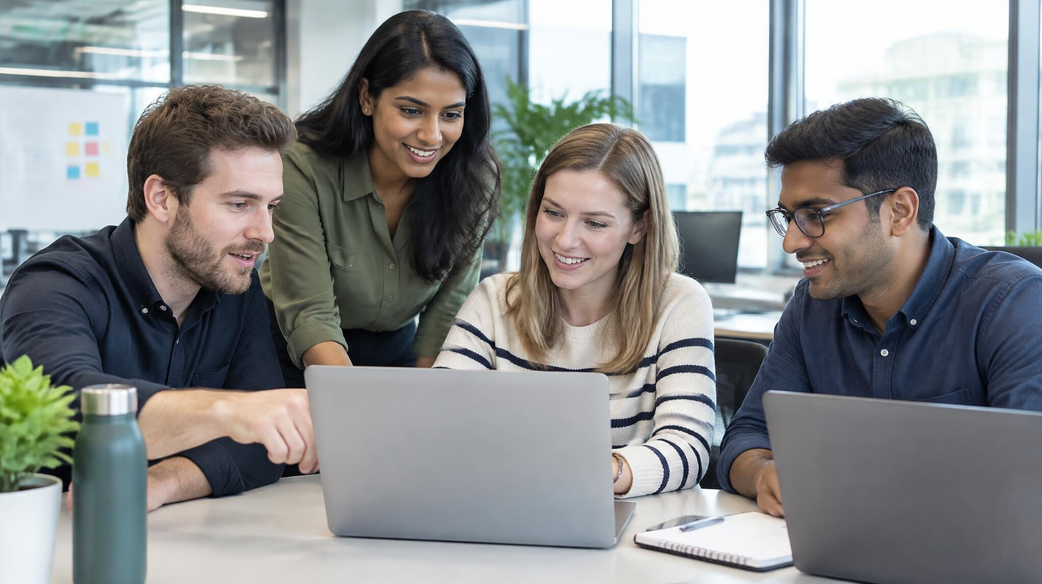 Colleagues working together at laptops in a modern office